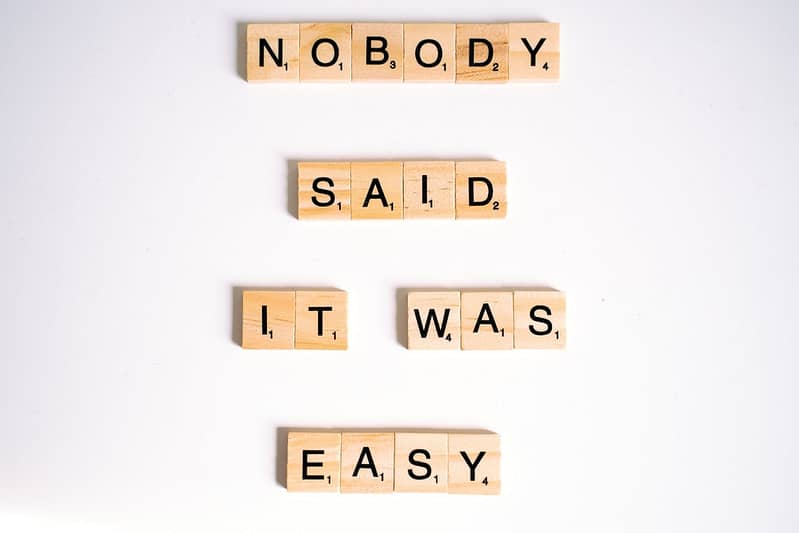 close up shot of scrabble tiles on a white surface